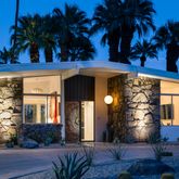 a view of a house with a yard and potted plants