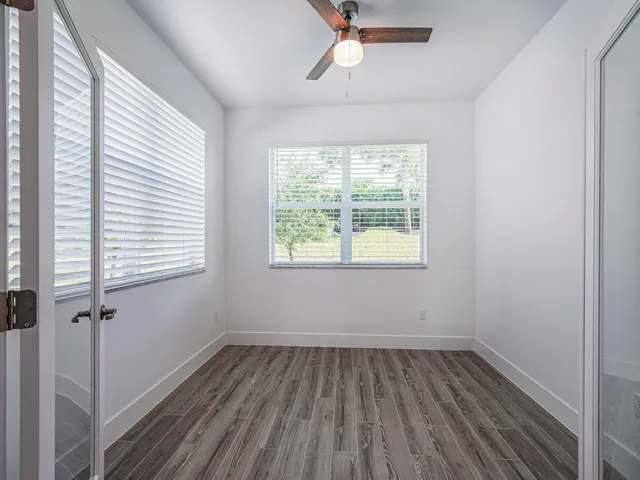 a view of a room with wooden floor and windows