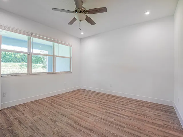 wooden floor in an empty room with a window