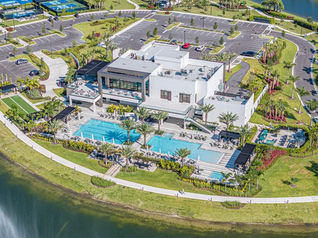 a view of swimming pool with a garden and plants
