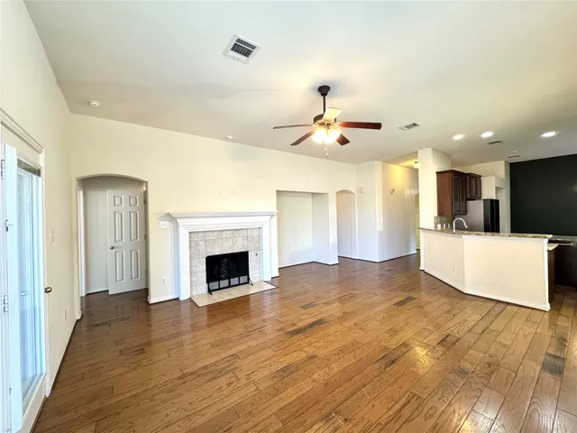 a spacious bedroom with a bed and a flat screen tv