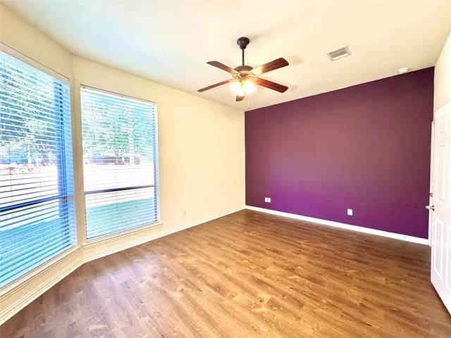 a bathroom with a large mirror vanity and a shower