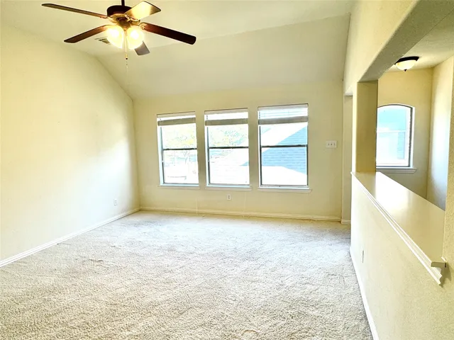 a bedroom with a bed a couch and potted plant