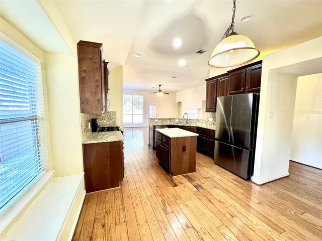 a kitchen with stainless steel appliances granite countertop a sink refrigerator and stove