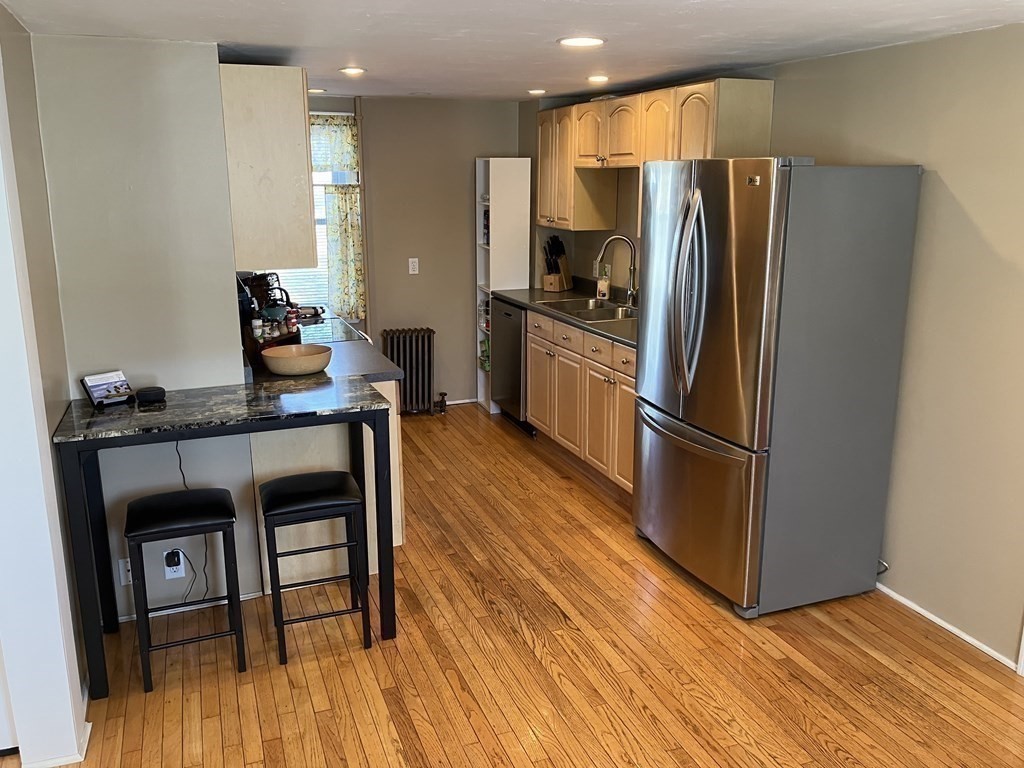 20 Cherry Street Hudson, MA 01749 - Photo 5 of 21 a kitchen with granite countertop a refrigerator and a stove top oven