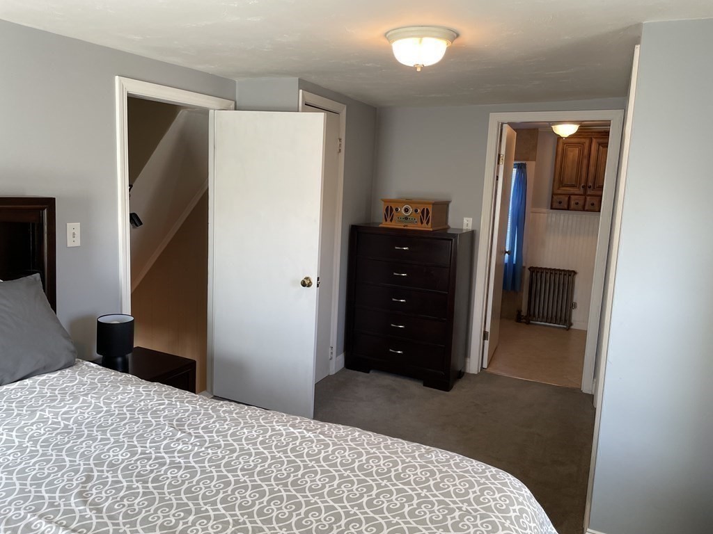 20 Cherry Street Hudson, MA 01749 - Photo 9 of 21 a bedroom with a bed and a flat tv screen