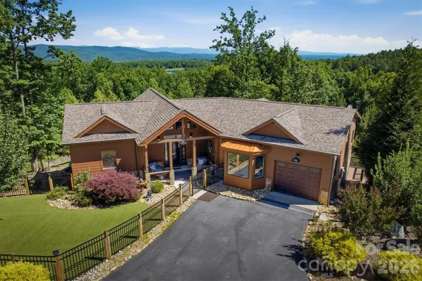an aerial view of a house with garden space and street view