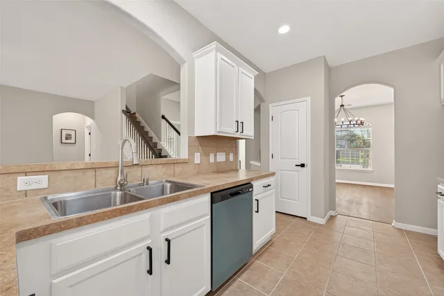 a bathroom with a double vanity sink mirror and shower