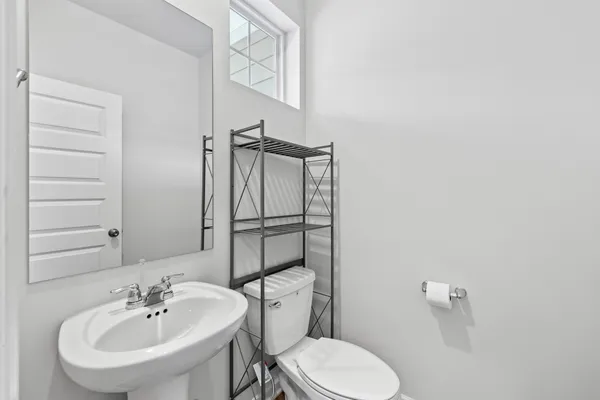 a bathroom with a sink a toilet and mirror