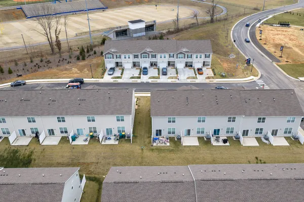 an aerial view of a house with a yard and lake view
