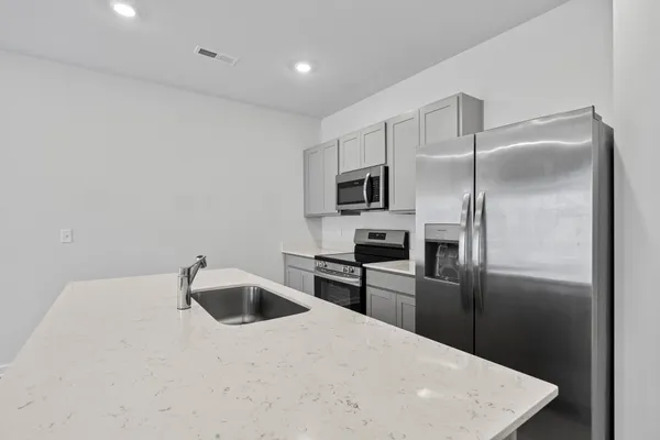 a kitchen with cabinets and stainless steel appliances