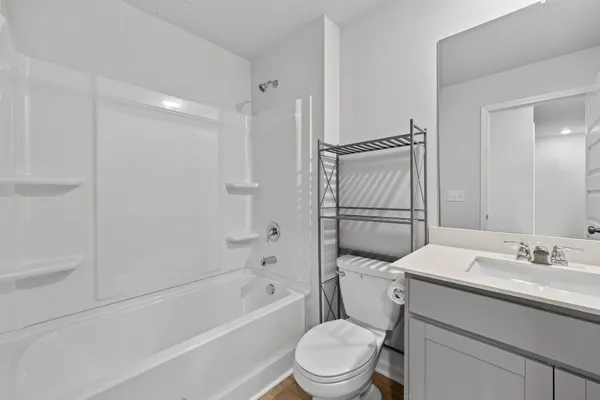 a bathroom with a granite countertop toilet sink and shower
