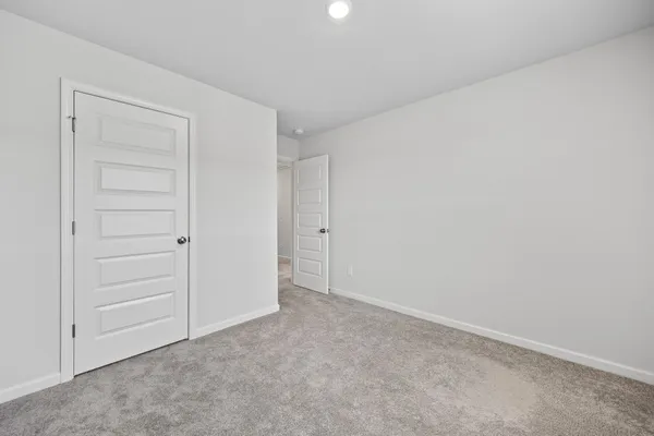 an empty room with closet area