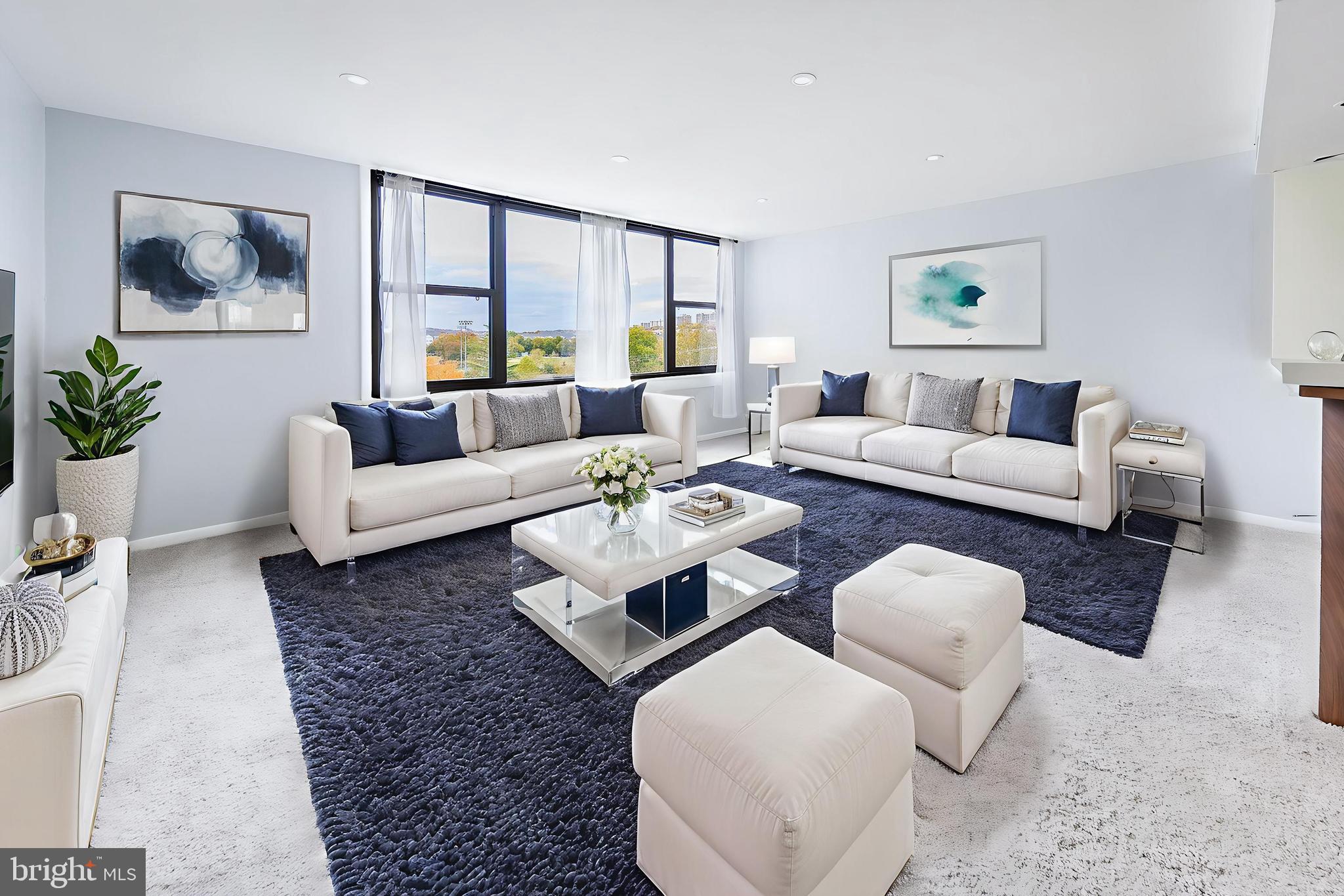 a living room with furniture or couch and a large window