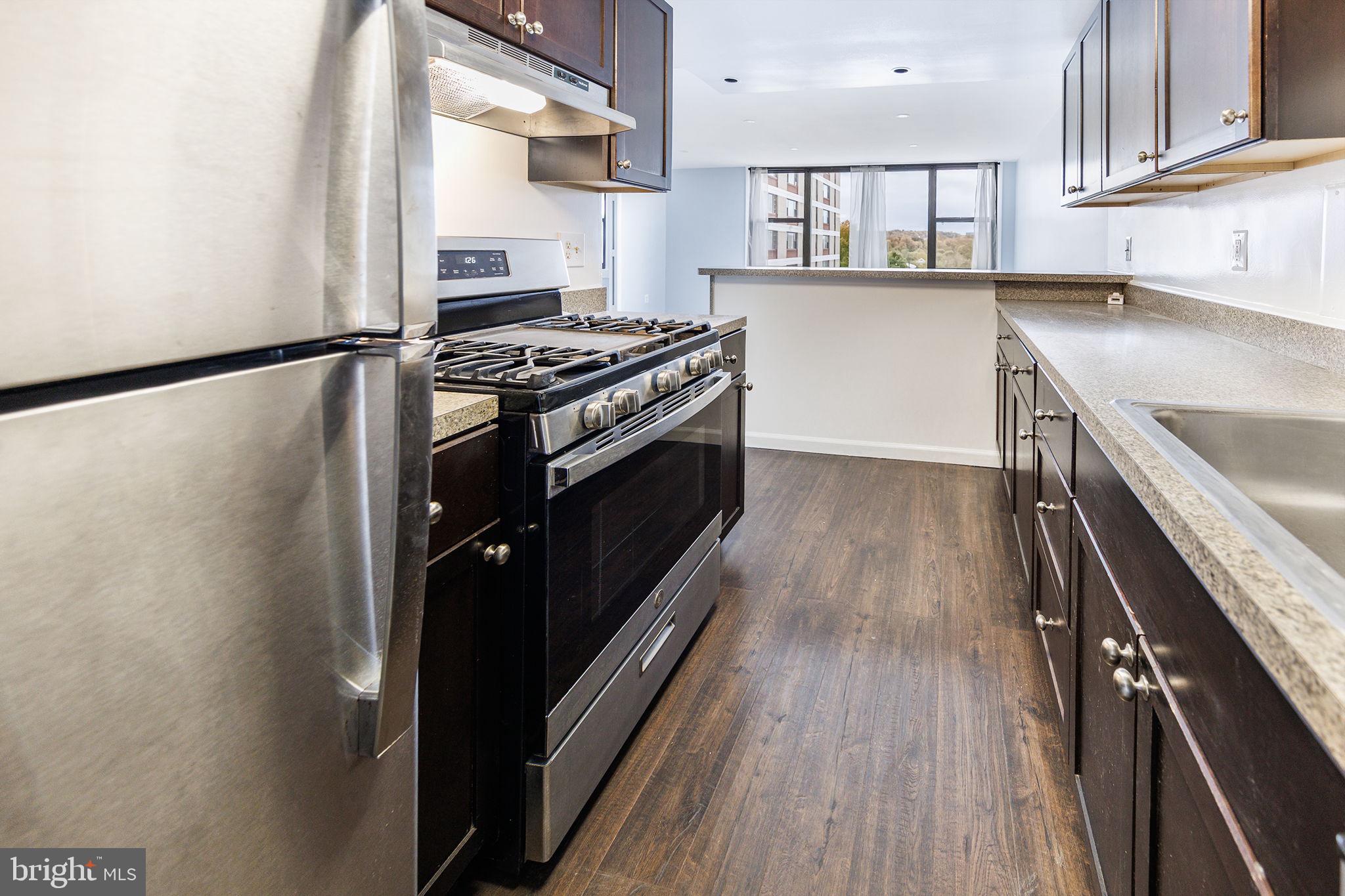 4600 Duke Street, Unit 622 Alexandria, VA 22304 - Photo 3 of 52 a kitchen with stainless steel appliances granite countertop a stove and a refrigerator