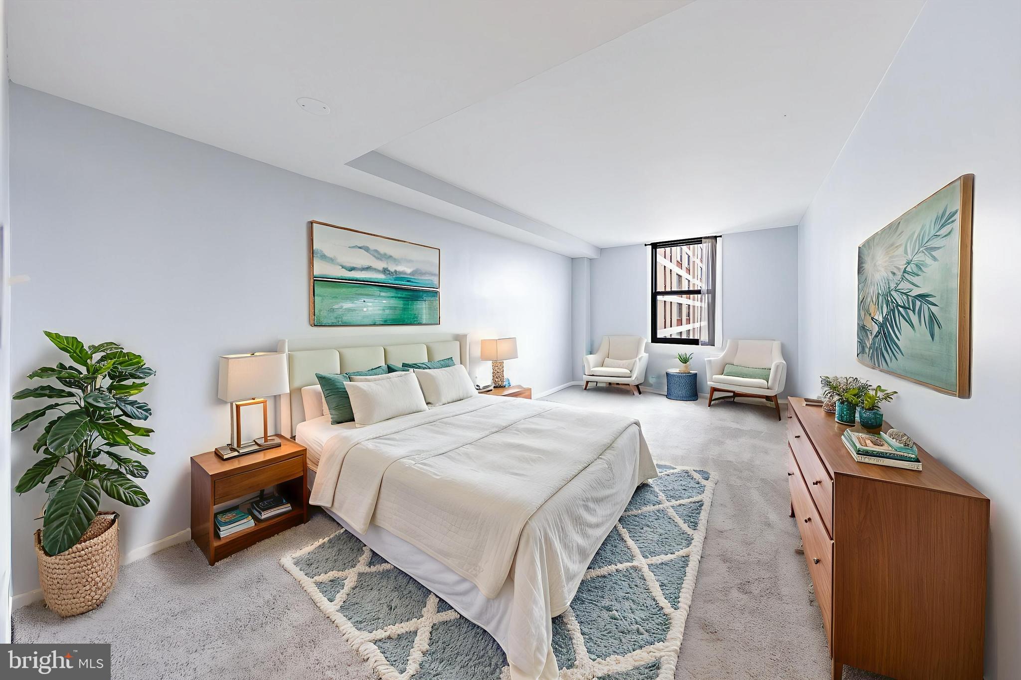 4600 Duke Street, Unit 622 Alexandria, VA 22304 - Photo 7 of 52 a spacious bedroom with a bed a couch and paintings on the wall