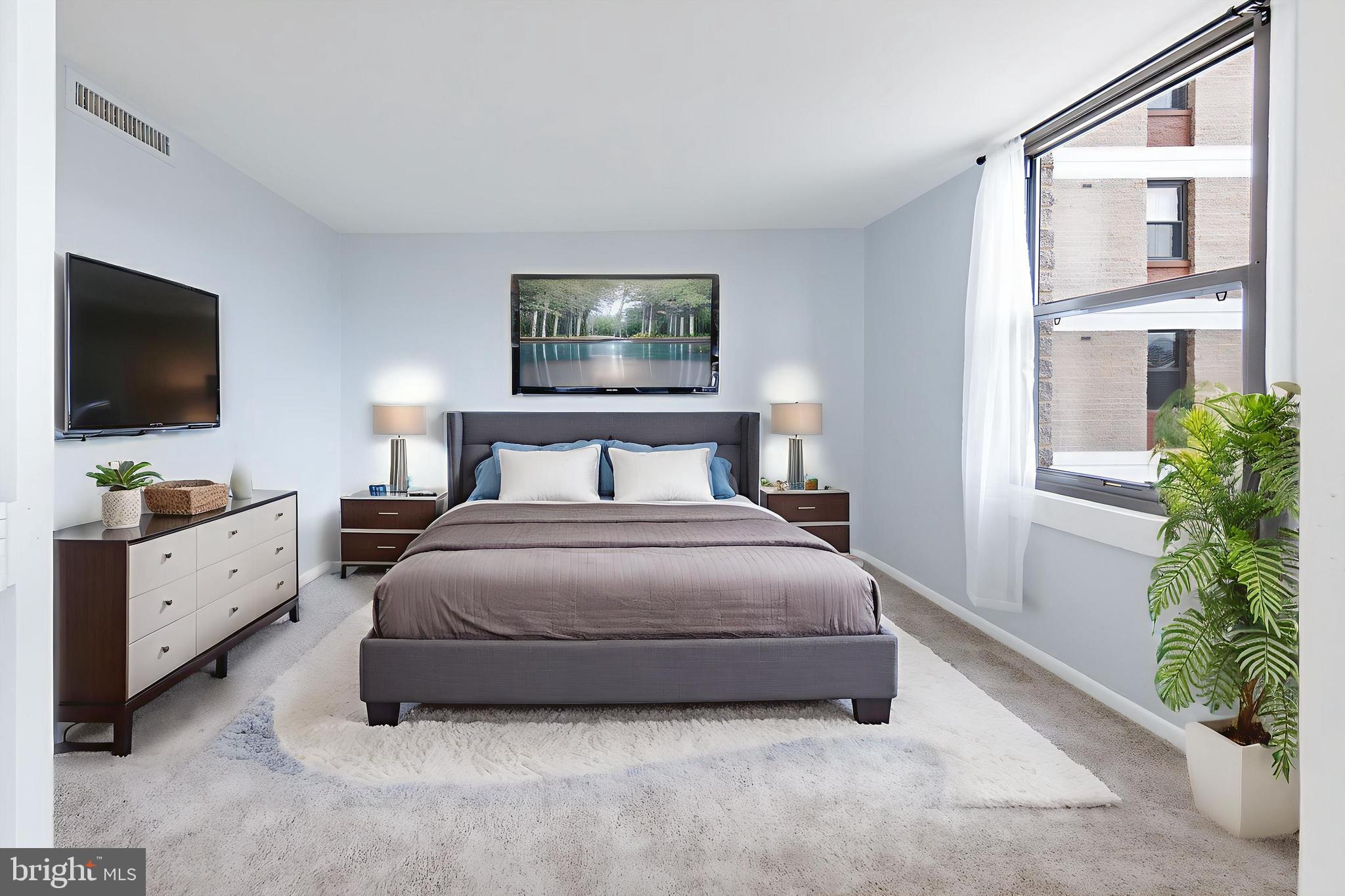 4600 Duke Street, Unit 622 Alexandria, VA 22304 - Photo 8 of 52 a bedroom with a bed and a flat screen tv