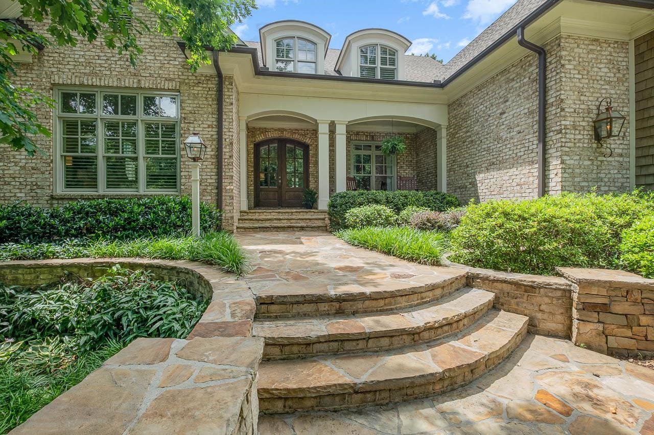 2129 Buckingham Road Raleigh, NC 27607 - Photo 2 of 52 Stone retaining walls and stone entry steps surrounded by professional lush landscape invite guests to your home. Beautiful Stone Entry