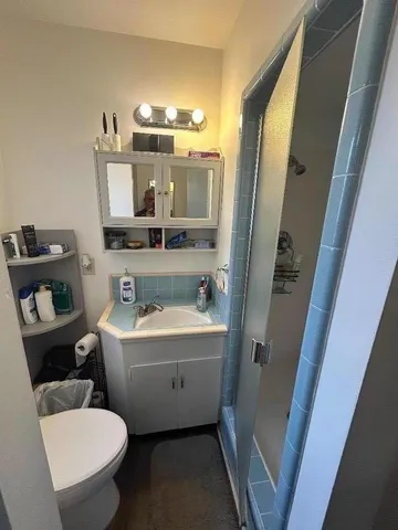 a bathroom with a bathtub sink mirror vanity and toilet
