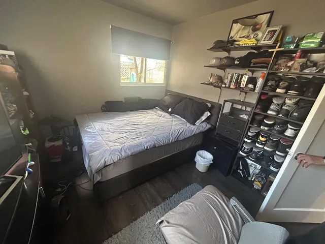 a bed sitting in a bedroom next to a window