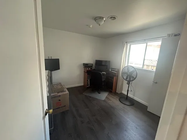 a view of workspace with wooden floor windows