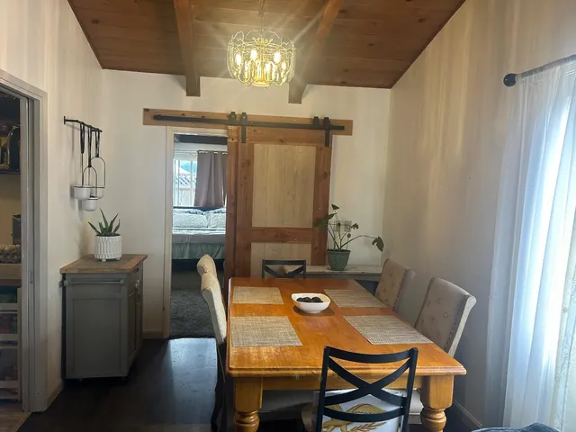a view of a dining room with furniture and window