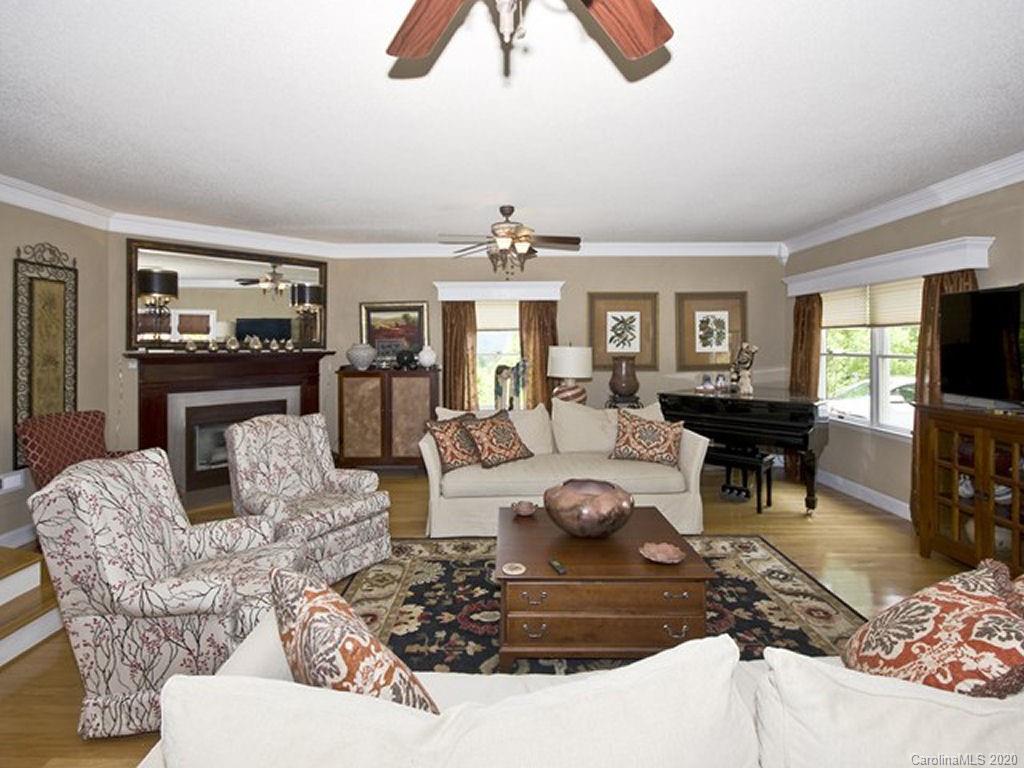 82 Gregg Roost Road Sylva, NC 28779 - Photo 18 of 35 a living room with furniture and a chandelier