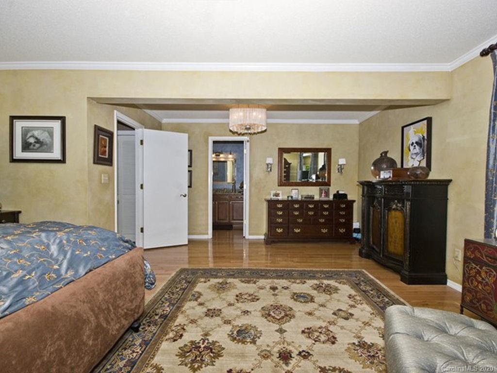 82 Gregg Roost Road Sylva, NC 28779 - Photo 24 of 35 a bedroom with a bed and a dresser