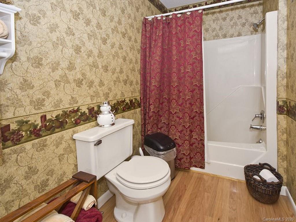 82 Gregg Roost Road Sylva, NC 28779 - Photo 30 of 35 a bathroom with a toilet and a shower