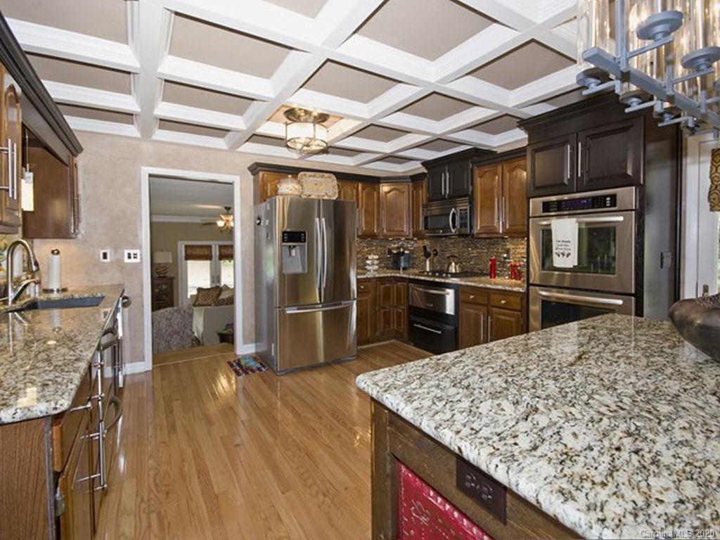 82 Gregg Roost Road Sylva, NC 28779 - Photo 34 of 35 a kitchen with stainless steel appliances granite countertop a sink stove and refrigerator