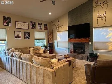 a living room with furniture fireplace and flat screen tv