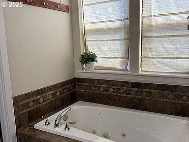 a bathroom with a bathtub and a window
