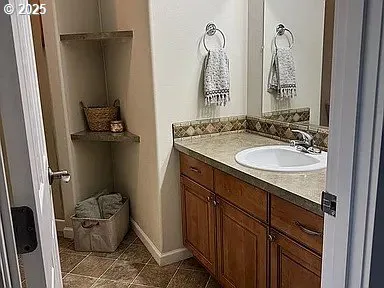 a bathroom with a sink and mirror with toilet