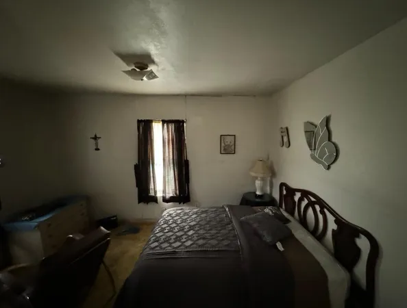 a bedroom with bed and window