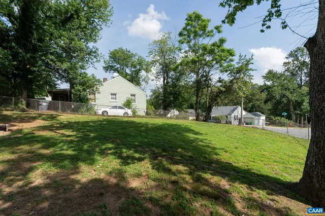 a view of a backyard with large trees