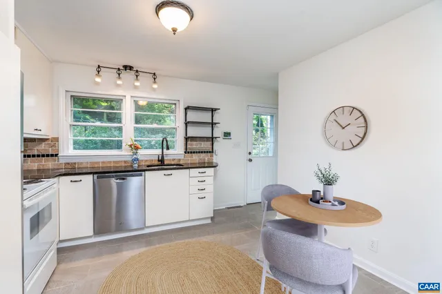 a kitchen with granite countertop a sink and a stove