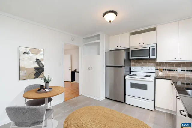 a kitchen with stainless steel appliances a stove a sink and a refrigerator