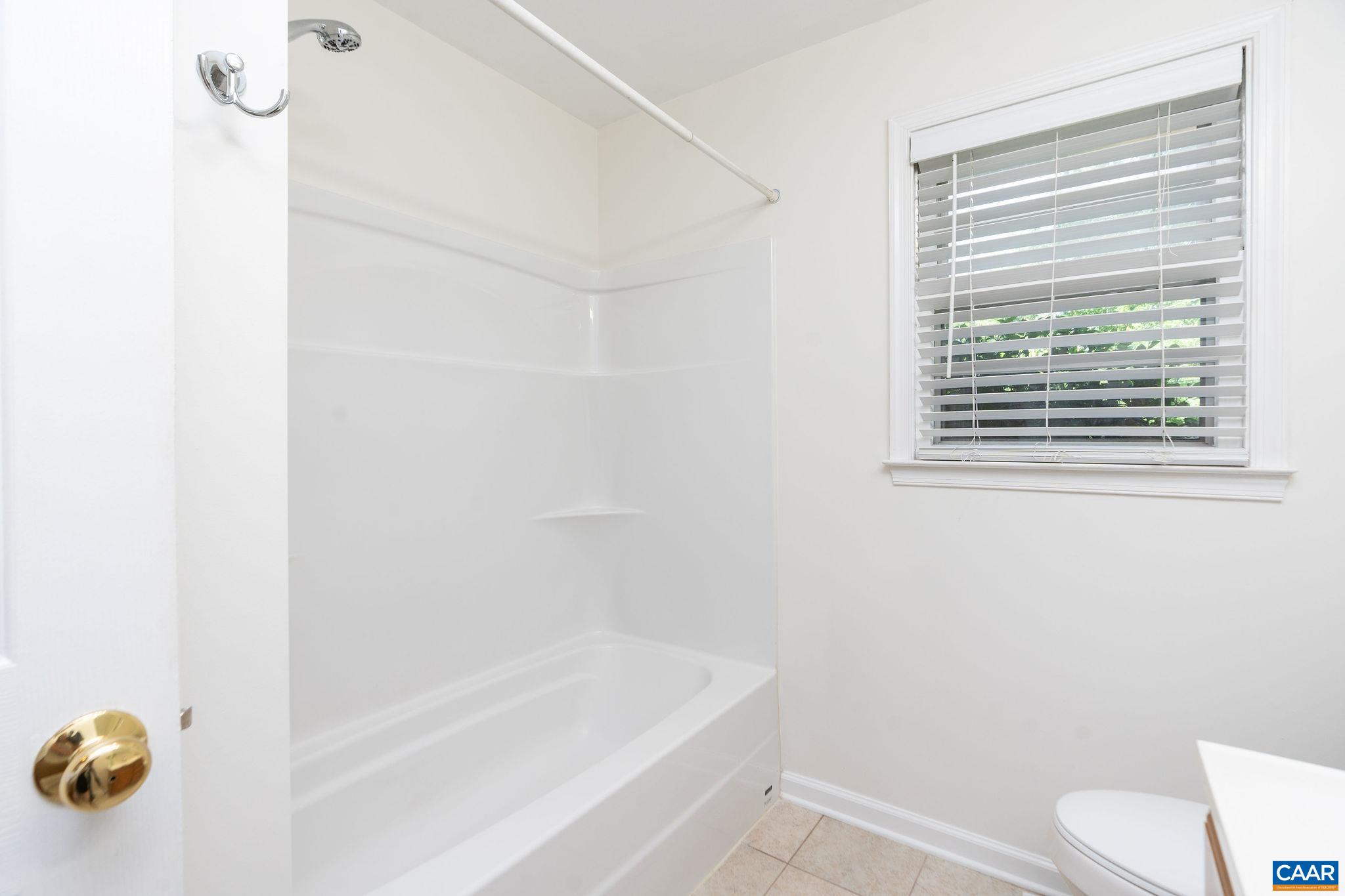 122 Westerly Avenue, Unit WHOLE HOUSE Charlottesville, VA 22903 - Photo 8 of 16 a bathroom with a bathtub and a toilet