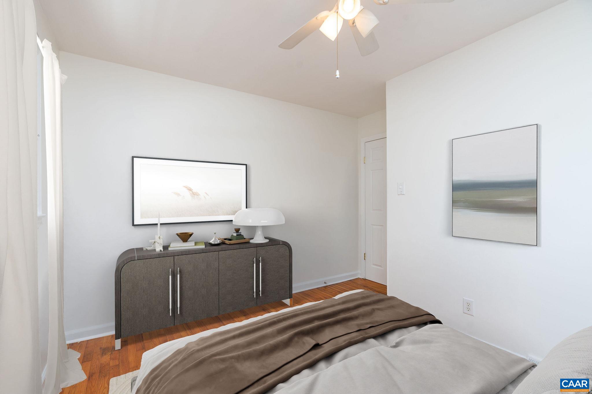 122 Westerly Avenue, Unit WHOLE HOUSE Charlottesville, VA 22903 - Photo 10 of 16 a bedroom with a bed and a chandelier