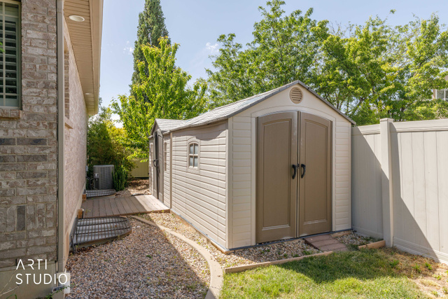2327 Bluff Ridge Drive Syracuse, UT 84075 - Photo 52 of 66 Outdoor storage shed featuring double doors and a gable roof