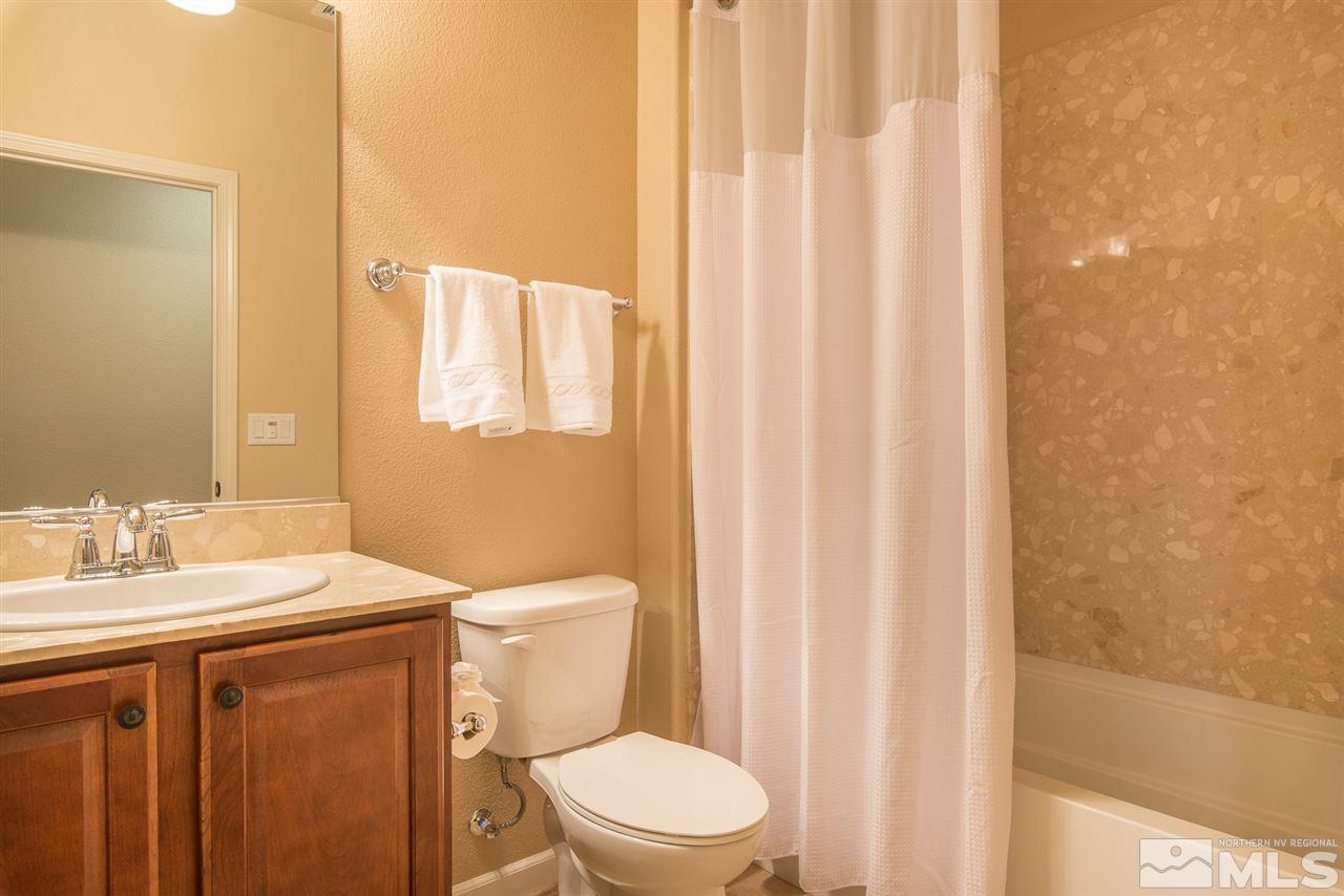 1180 Callaway Trail Reno, NV 89523 - Photo 14 of 19 a bathroom with a sink a toilet and shower curtain