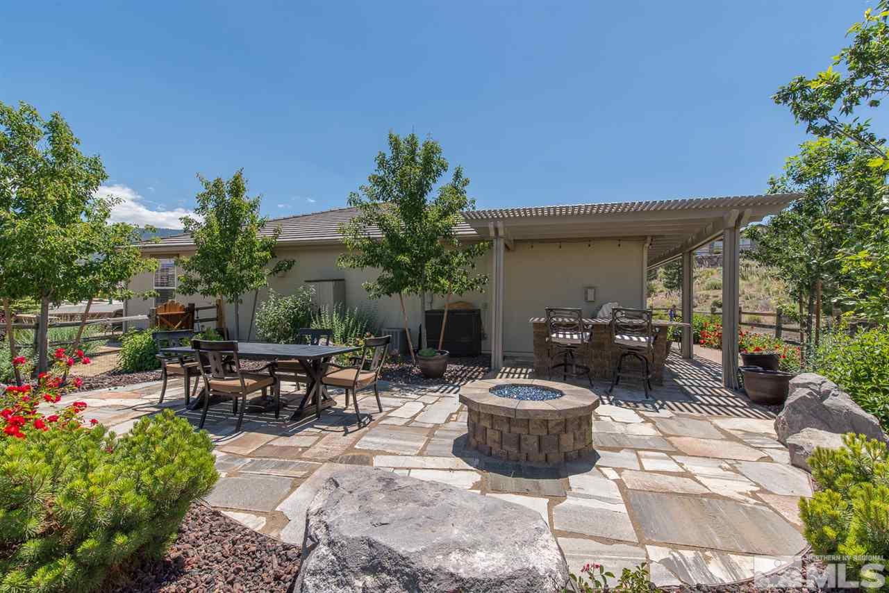 1180 Callaway Trail Reno, NV 89523 - Photo 17 of 19 a view of a patio with table and chairs potted plants and a palm tree