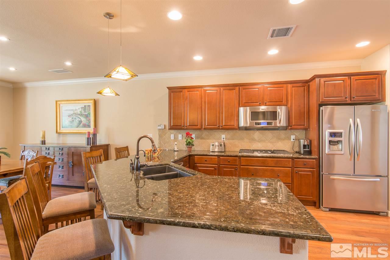 1180 Callaway Trail Reno, NV 89523 - Photo 5 of 19 a kitchen with stainless steel appliances granite countertop a sink refrigerator and cabinets