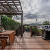 a view of a roof deck with wooden floor and fence