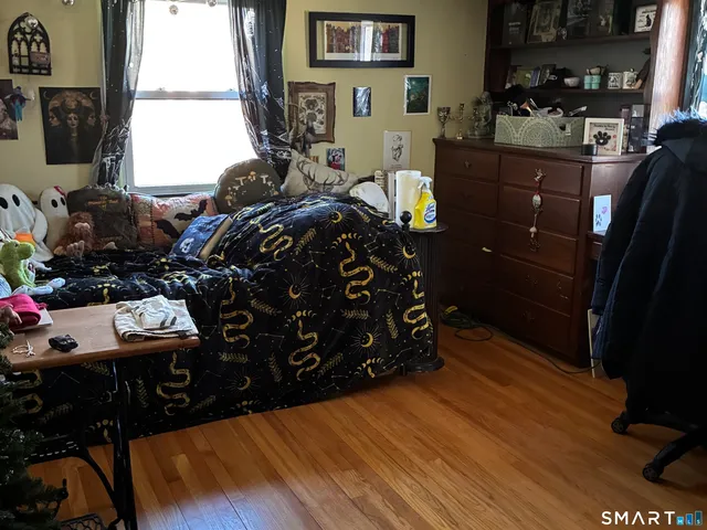 a bed room with wooden floor and furniture