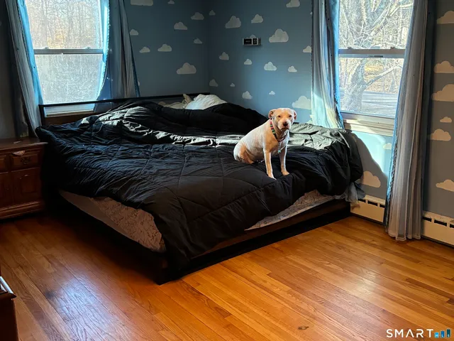 a bed sitting in a bedroom next to a window