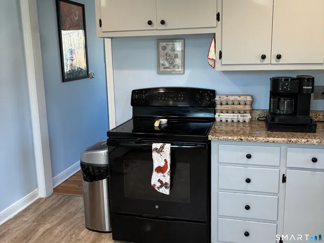 a stove top oven sitting inside of a kitchen