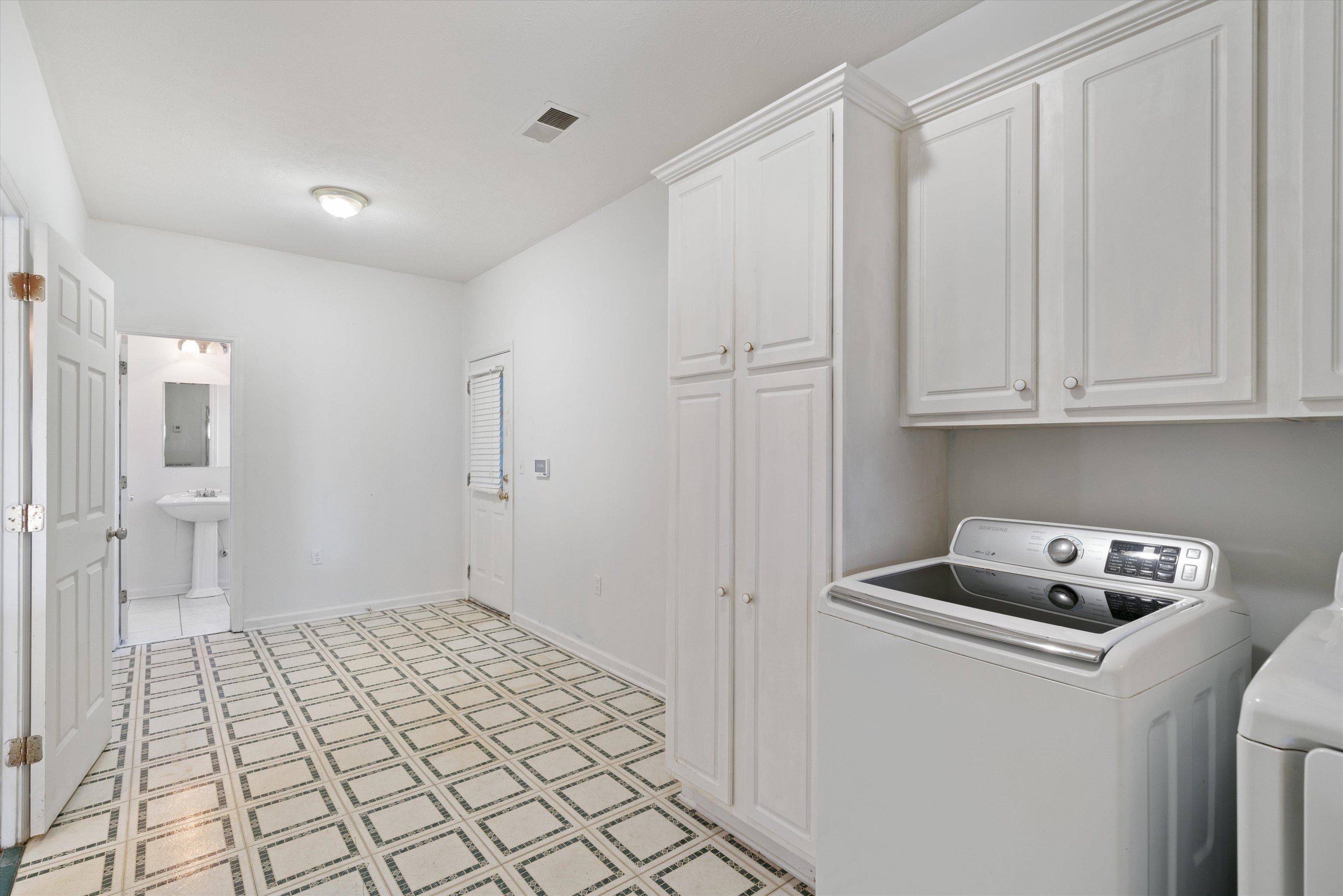 130 Belmont Road Mason, TN 38049 - Photo 13 of 24 Laundry area with cabinets, electric panel, and washer and dryer