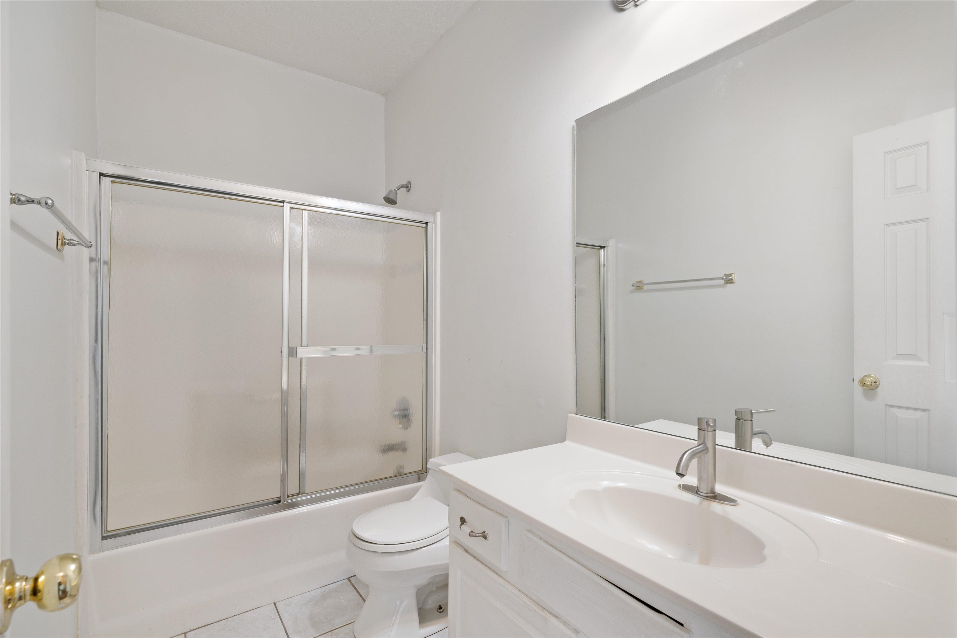 130 Belmont Road Mason, TN 38049 - Photo 20 of 24 Full bathroom with tile patterned flooring, vanity, shower / bath combination with glass door, and toilet