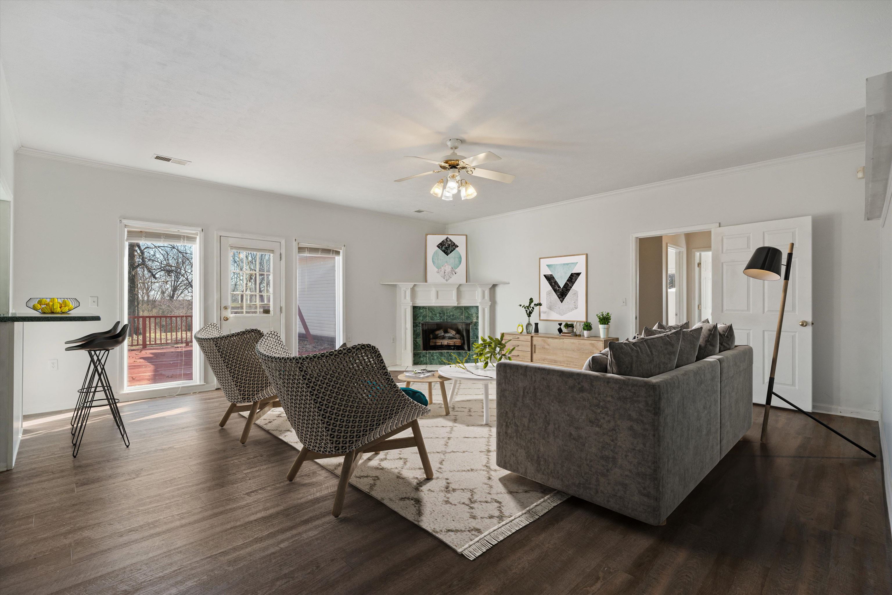 130 Belmont Road Mason, TN 38049 - Photo 7 of 24 Living room featuring ceiling fan, ornamental molding, a premium fireplace, and dark hardwood / wood-style flooring